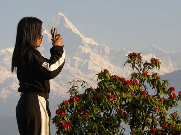 female trekker taking picture at viewpoint