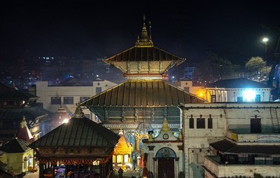 The golden roof of the main Pashupatinath Temple illuminated at night, capturing the peaceful and highly energetic spiritual atmosphere of the sacred complex