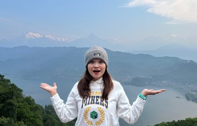 Traveler enjoying the panoramic view of Phewa Lake and the Annapurna mountains