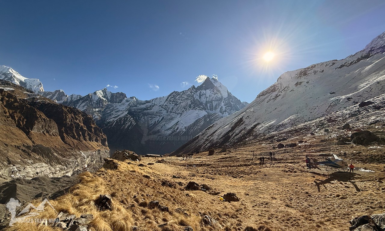 Wide aerial view of the Annapurna Base Camp trekking trail with a helicopter landing