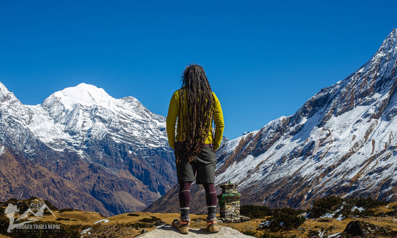 yogi hiker standaing on top and looking the himalayas