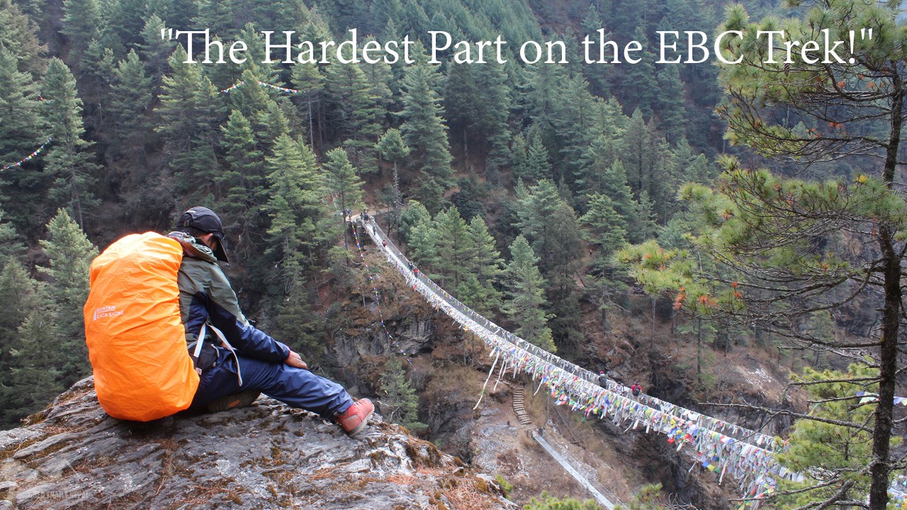 Trekking from Phakding to Namche Bazaar - A trekker looking over a high suspension bridge in the Khumbu region of Nepal.