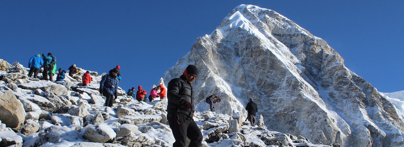 The Hardest Part on the EBC Trek - scenic Himalayan mountain range view with Buddhist prayer shrines and Rugged Trails Nepal branding.
