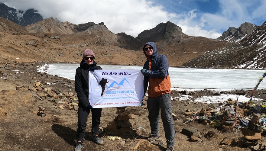 Two trekkers holding a 